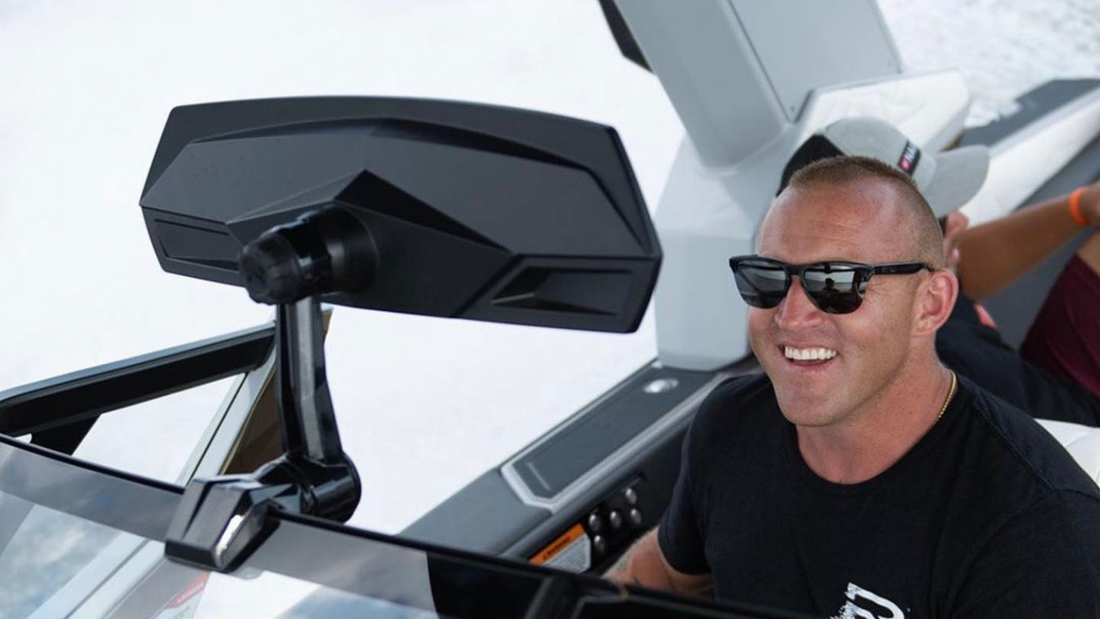 Guy smiling with Roswell Marine mirror in frame