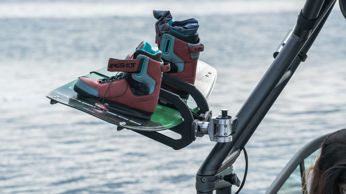 wake board being held by Roswel Marine wakeboard rack, attached to boat tower